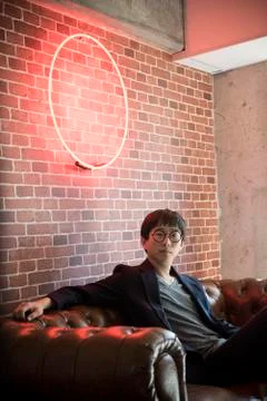 Man sitting on sofa, portrait Stock Photos