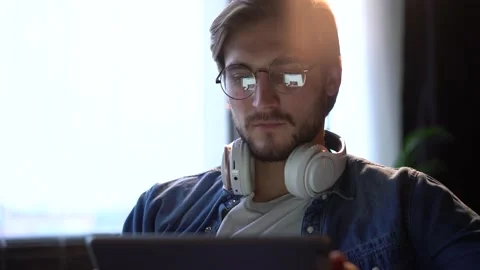 Man sitting on sofa, using gadget, tablet computer, staying busy on weekend. Stock Footage 143911711
