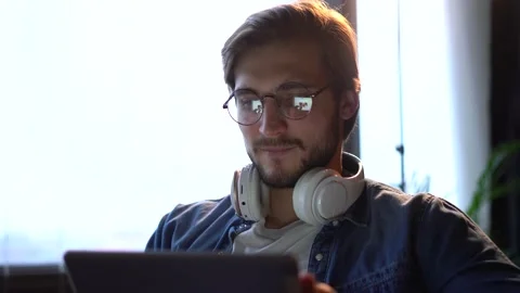 Man sitting on sofa, using gadget, tablet computer, staying busy on weekend. Stock Footage 143911720