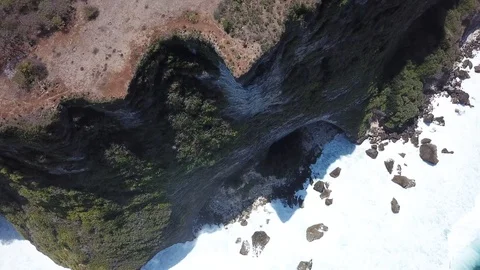 Man Sitting on Steep Cliff [Drone Footage] Stock Footage 96236536