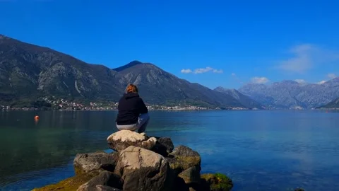 Man Sitting on the Stone with View of Kotor Bay Stock Footage 237998986