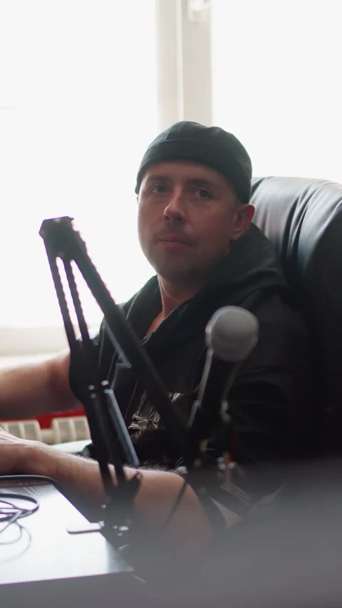 Man Sitting in a Studio Room Wearing Black Clothes Working on a Computer Stock Footage 309710148