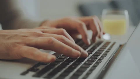 Man sitting at table and typing Stock Footage 234347300