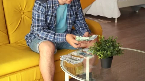 A man sitting at the table counting money Video stock 157697337