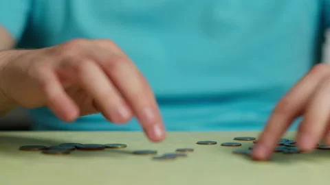 Man sitting at the table counts coins, close up Stock Footage 145325843