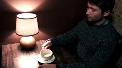 Man sitting at the table drinking coffee Video stock 56250916