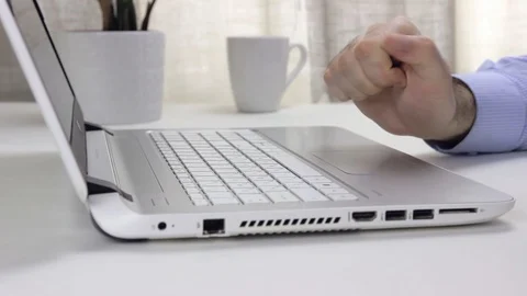 Man sitting at a table in front of a laptop Stock Footage 128104218