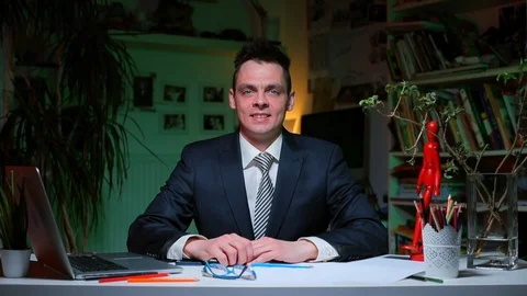 A man sitting at the table shows an emotion of chagrin and an emotion of joy. Video stock 128027686