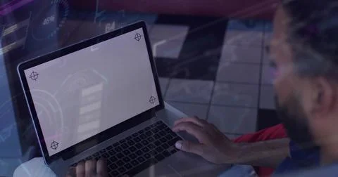 Man sitting at table, tapping trackpad while starting HUD for UI mockup showing 库存照片