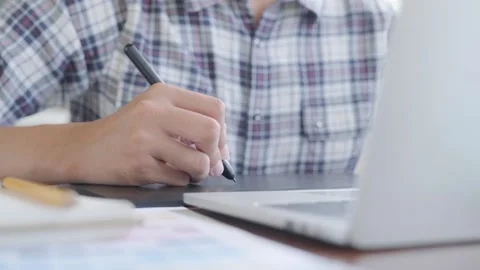 A man sitting at a table using a laptop 库存影片 156845963