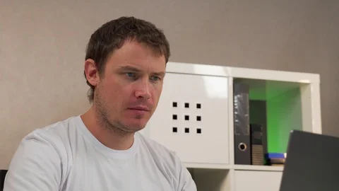 Man sitting at table working on laptop Stock Footage 129049292