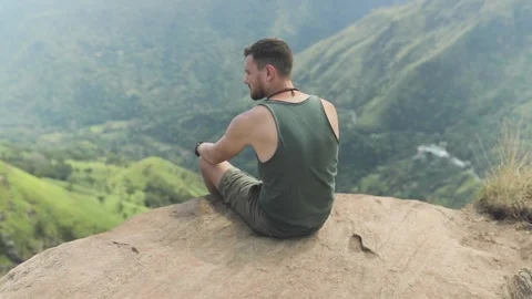 Man sitting on top of mountain Stock Footage 108632960