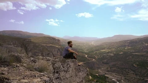 Man Sitting on top of Mountain Thinking and Hope Stock Footage