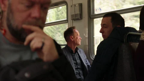 Man is sitting in the train, looking through the window. Stock Footage 188841565