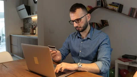 Man sitting using laptop and credit card make a payment on-line. Stock Footage 170956856