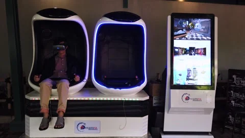 A Man Sitting on Virtual Reality Game Capsule, Floating Market Lembang Video stock 130249810
