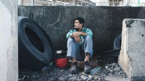 A man sitting by a wall 스톡 사진