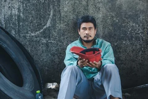 A man sitting by a wall 스톡 사진