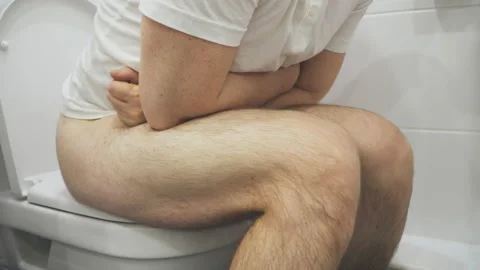 Man sitting on wc and suffering from diarrhea. Video stock 99986891
