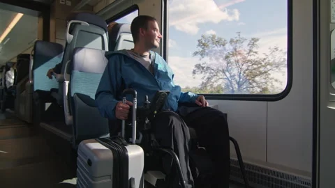 Man sitting in a wheelchair inside a train accessible for people with disability 動画素材 301234500