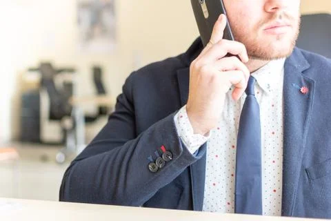 Man sitting while using the mobile smartphone. Confident Entrepreneur working on Stock Photos