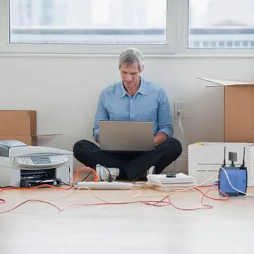 Man sitting while working on computer network Foto stock