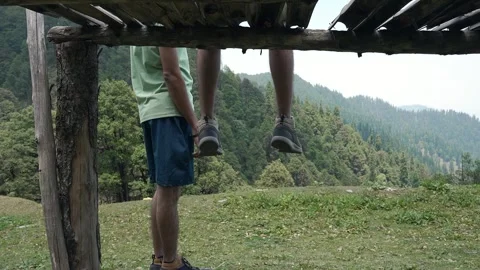 Man sitting on a wooden platform overlooking Himalayan views Stock Footage 336247607