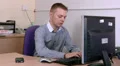 Man sitting at work puts hands to head HD Footage