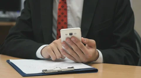 Man sitting writing the text using the smartphone Stock Footage 68897219