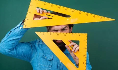 Man with size measured on triangle ruler math tool, school stem disciplines Stock Photos