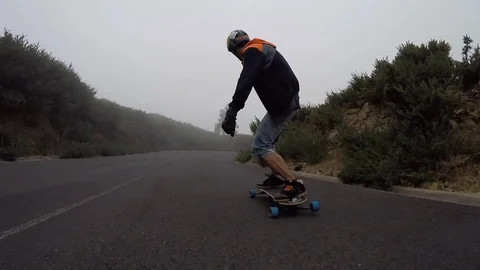Man with skateboard perform tricks on asphalt road Stock Footage 105590243