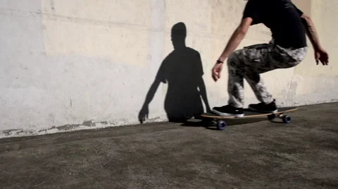 A man on a skateboard rides through frame Video stock 41059706
