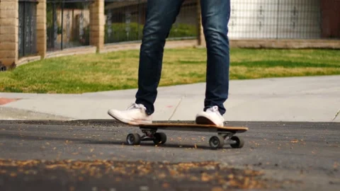 Man skateboarding skating around empty suburb street alone relaxing and joyful Stock Footage 154760127