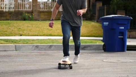 Man skateboarding skating around empty suburb street alone relaxing and joyful Stock Footage 154760179