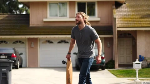 Man skateboarding skating around empty suburb street alone relaxing and joyful Stock Footage 154760232