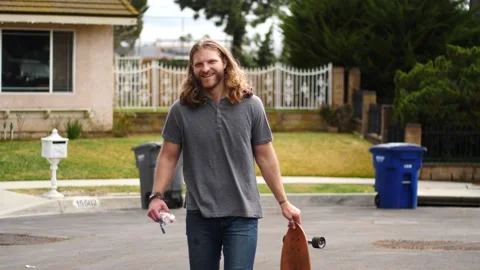 Man skateboarding skating around empty suburb street alone relaxing and joyful Stock Footage 154760385