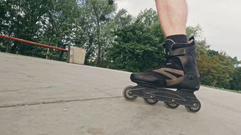 Man skates on roller blades in extreme park Stock Footage 312470267