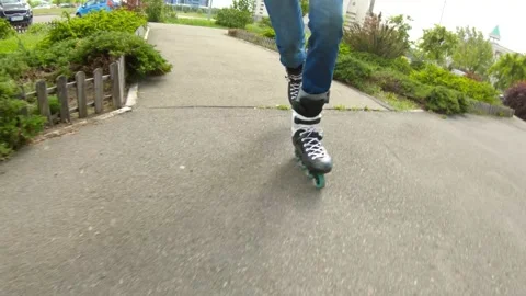 Man skating on inline skates outdoor with selfie stick Stock Footage 130849822