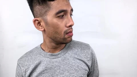 Man with a skeptical expression, looking directly at the camera. Stock Footage 315231284