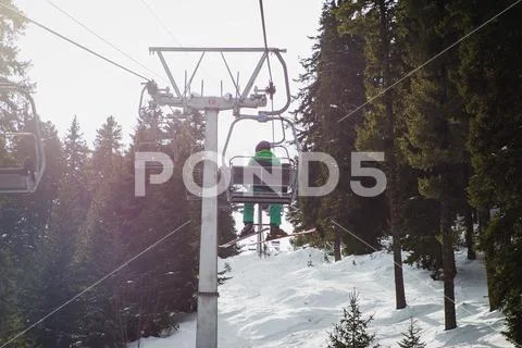 Man with ski on the chairlift, traveling to the Seven Rila Lakes, Bulgaria. Stock Photos