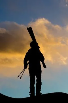 Man with ski equipment at sunset Stock Illustration