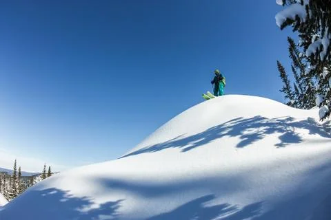 Man skier freerider standing at top of ridge, adventure winter freeride extre Stock Photos