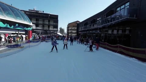 Man is skiing down to the line of people on the ski elevator. Stock Footage 219001823