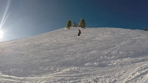 Man skiing in the hillside with sun piercing in the background Stock Footage 85266073
