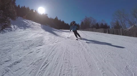 Man skiing towards camera at speed on piste stabilized Stock Footage 62526194