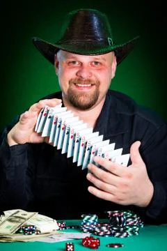 Man skilfully shuffles playing cards Stock Photos