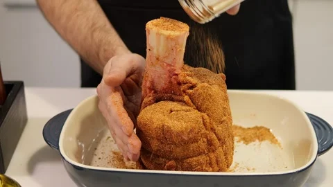 Man skillfully cooks meat with the addition of aromatic spices, giving it a rich Stock Footage 270442881