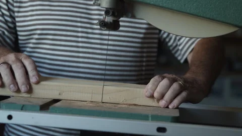 Man skillfully operates table saw for wood cutting in workshop Stock Footage 312713471
