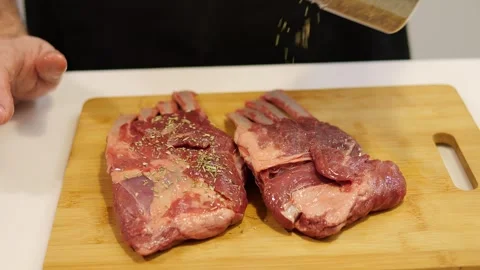 The man skillfully seasons the beef with aromatic spices, giving it a rich taste Stock Footage 270520172