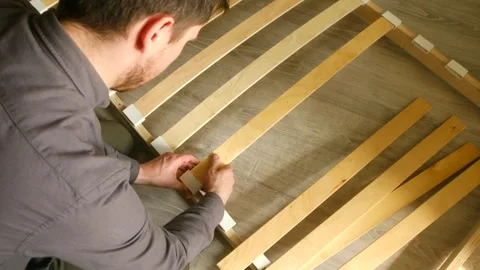 Man skillfully slats assembly bed frames. Each step executed precision restoring Stock Footage 312986545